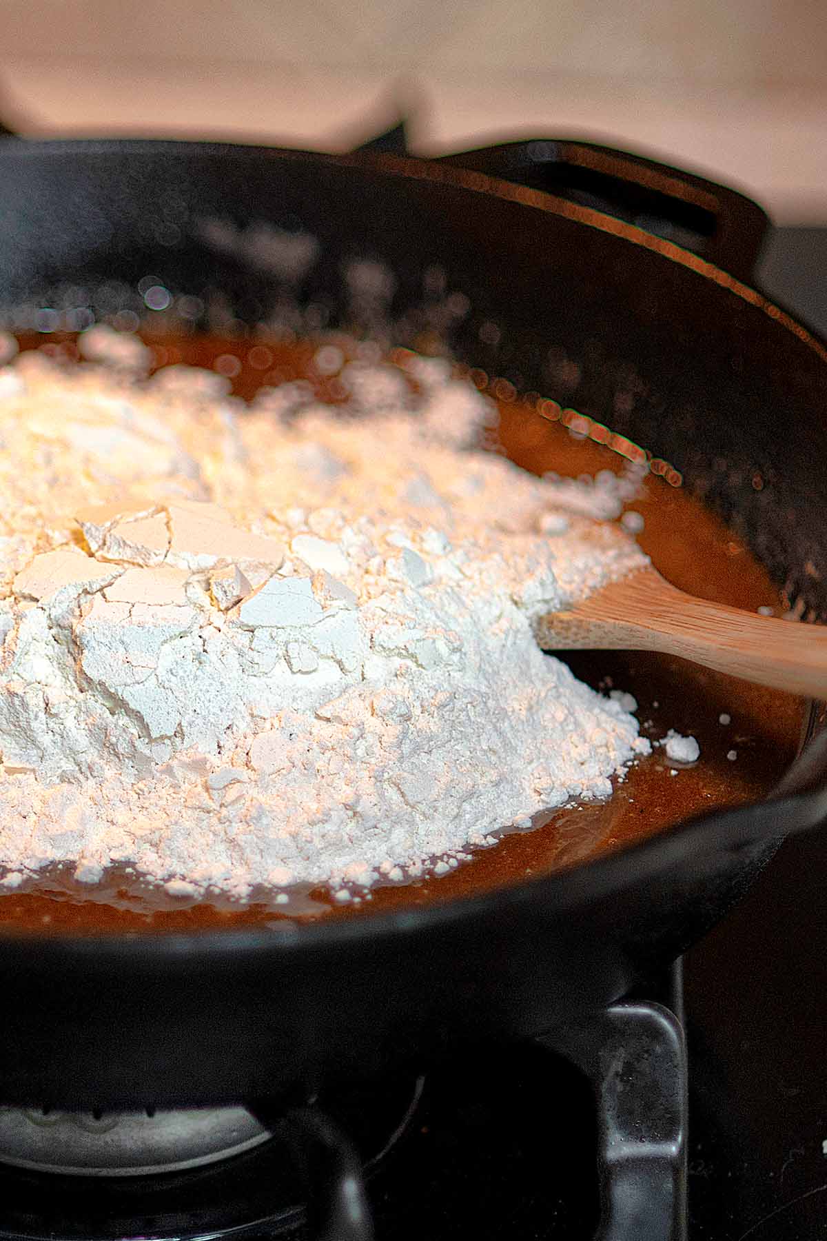 Dry ingredients added to a cast iron skillet for cookie dough.