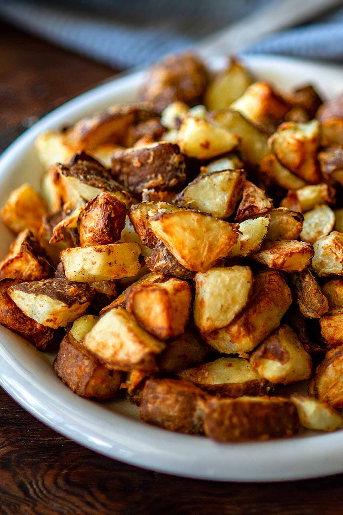 Air fryer rosemary potatoes served on a white plate. 