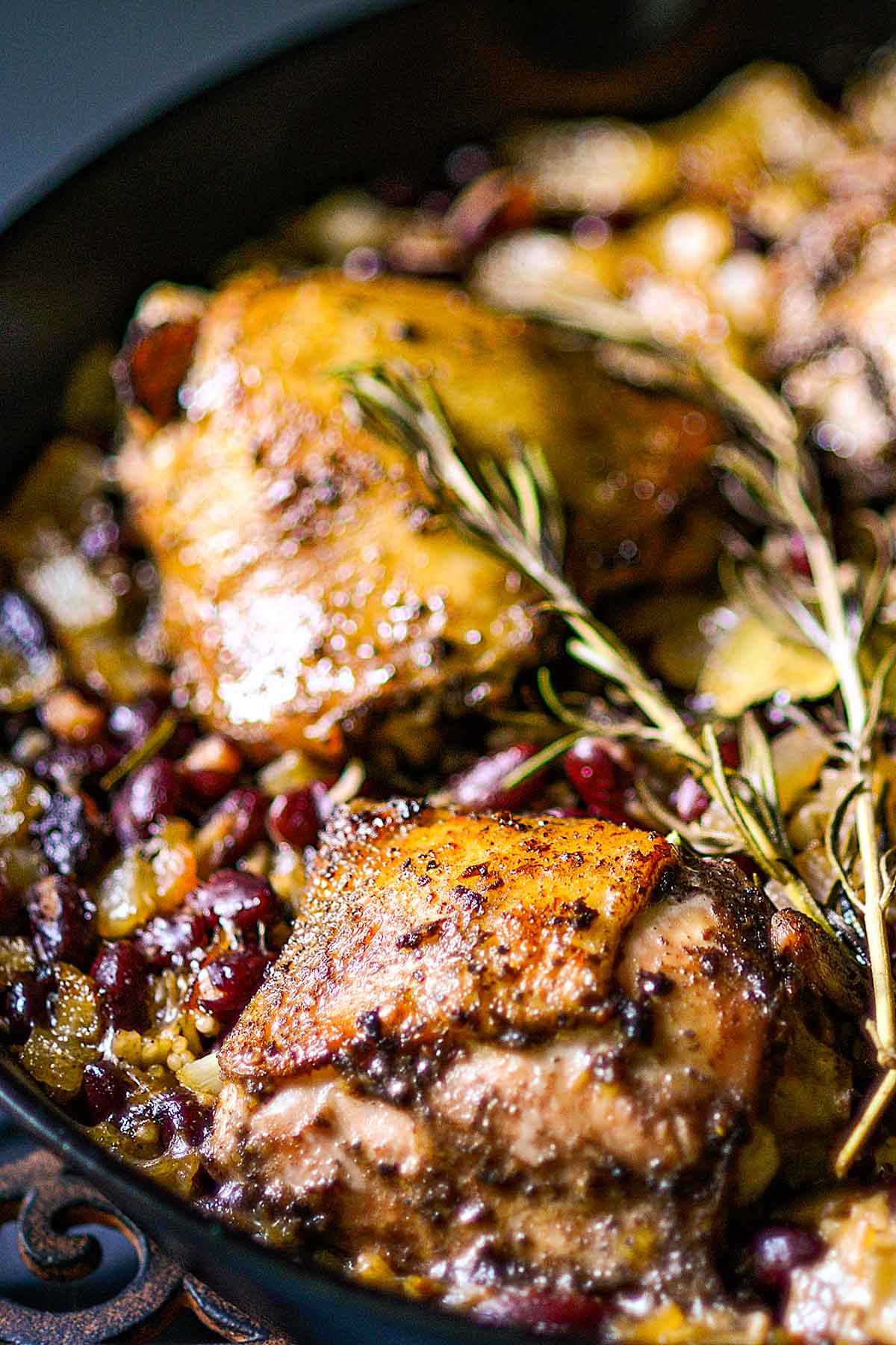 Jamaican jerk chicken thighs with red beans and coconut rice fully cooked in a cast iron skillet.