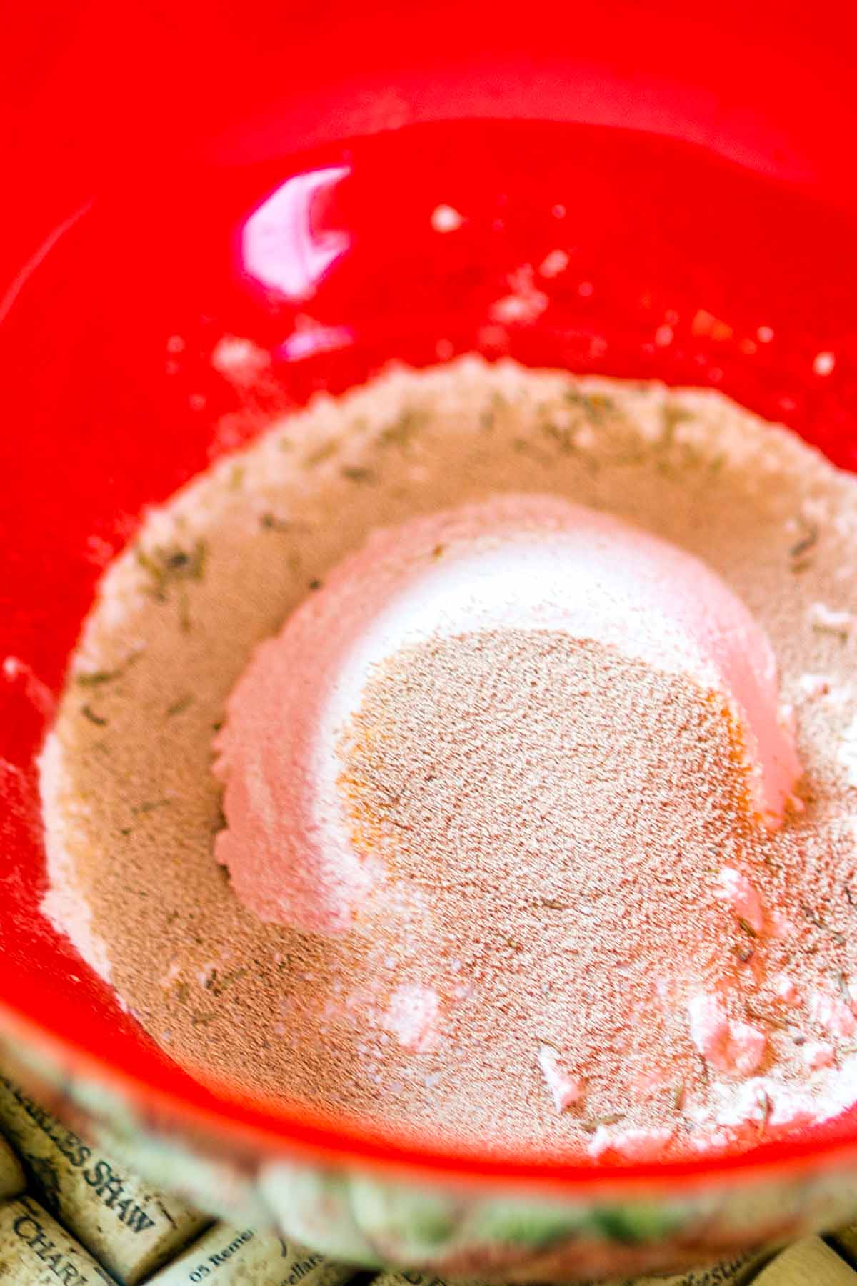 Flour and yeast in a red bowl.