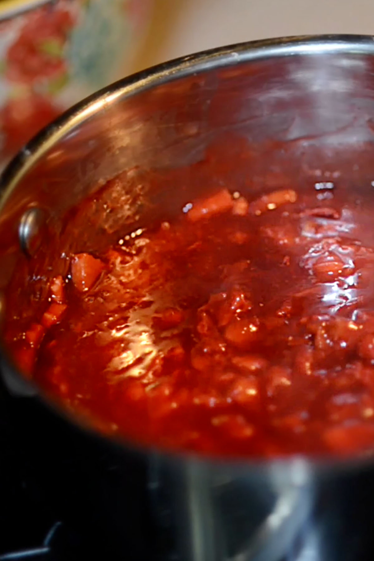 Strawberry Rhubarb jam simmering in a pot.