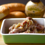 Homemade Sheboygan Style Bratwurst with Onions, Buns, and Mustard.