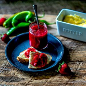 Strawberry Rhubarb Preserve with Hatch Green Chiles Jarred and served on toast.
