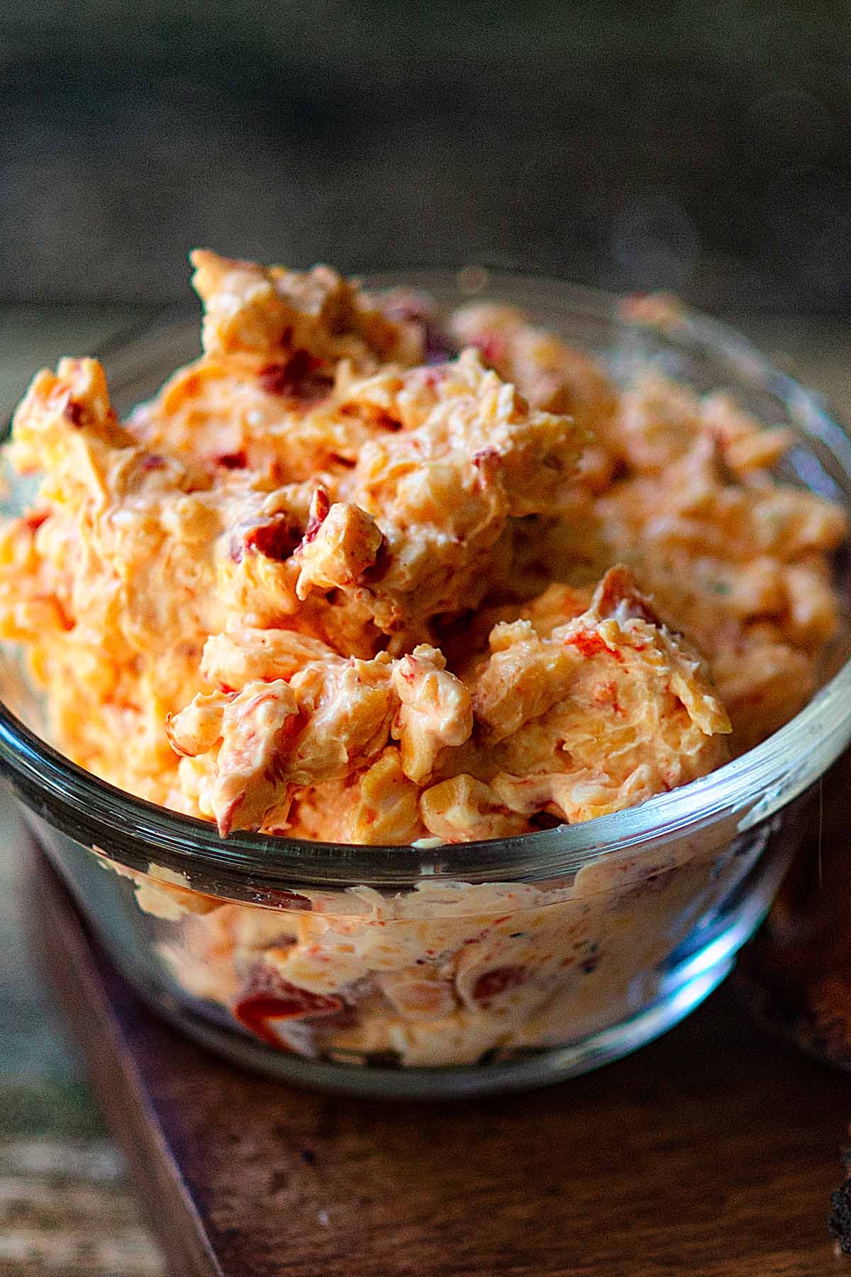 Homemade pimento cheese served in a clear dish.