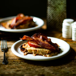 Kentucky Hot Brown Sandwiches served on white plates.