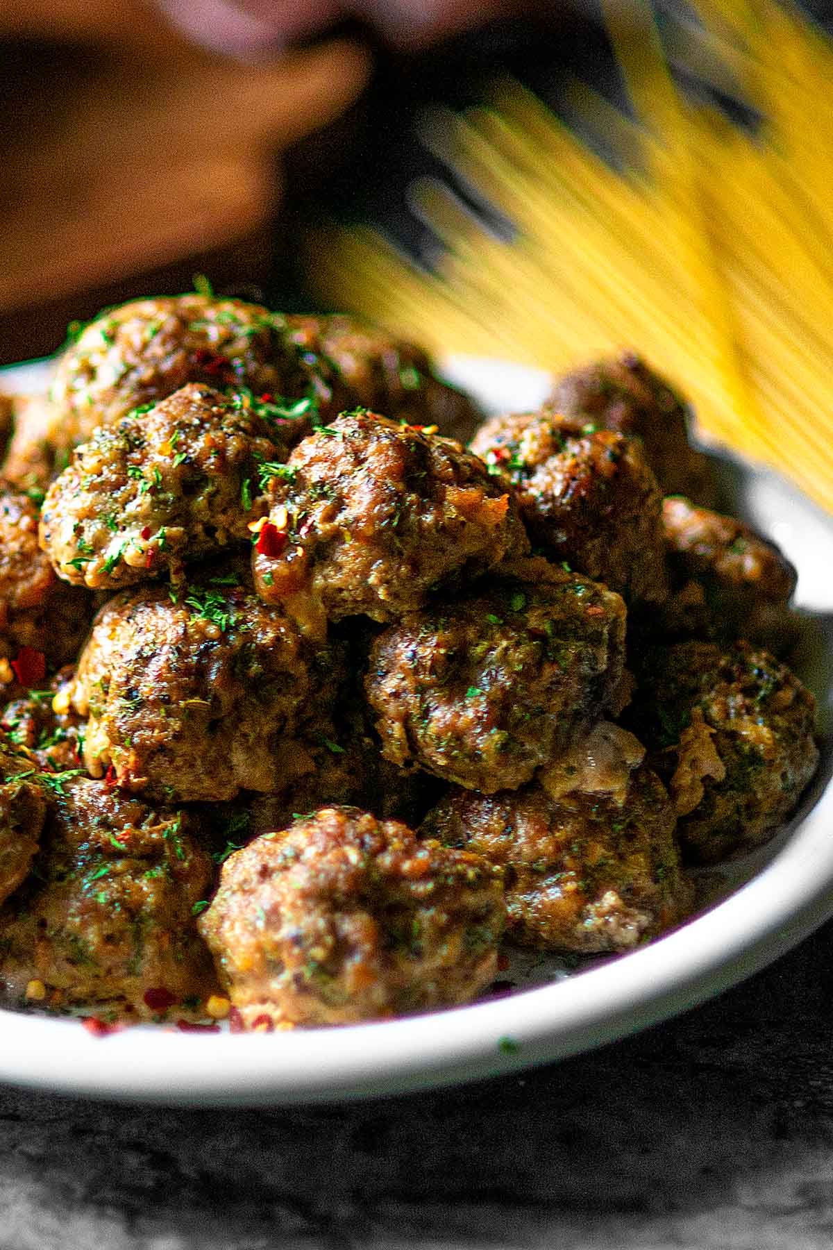 Italian Meatballs stacked on a white plate.