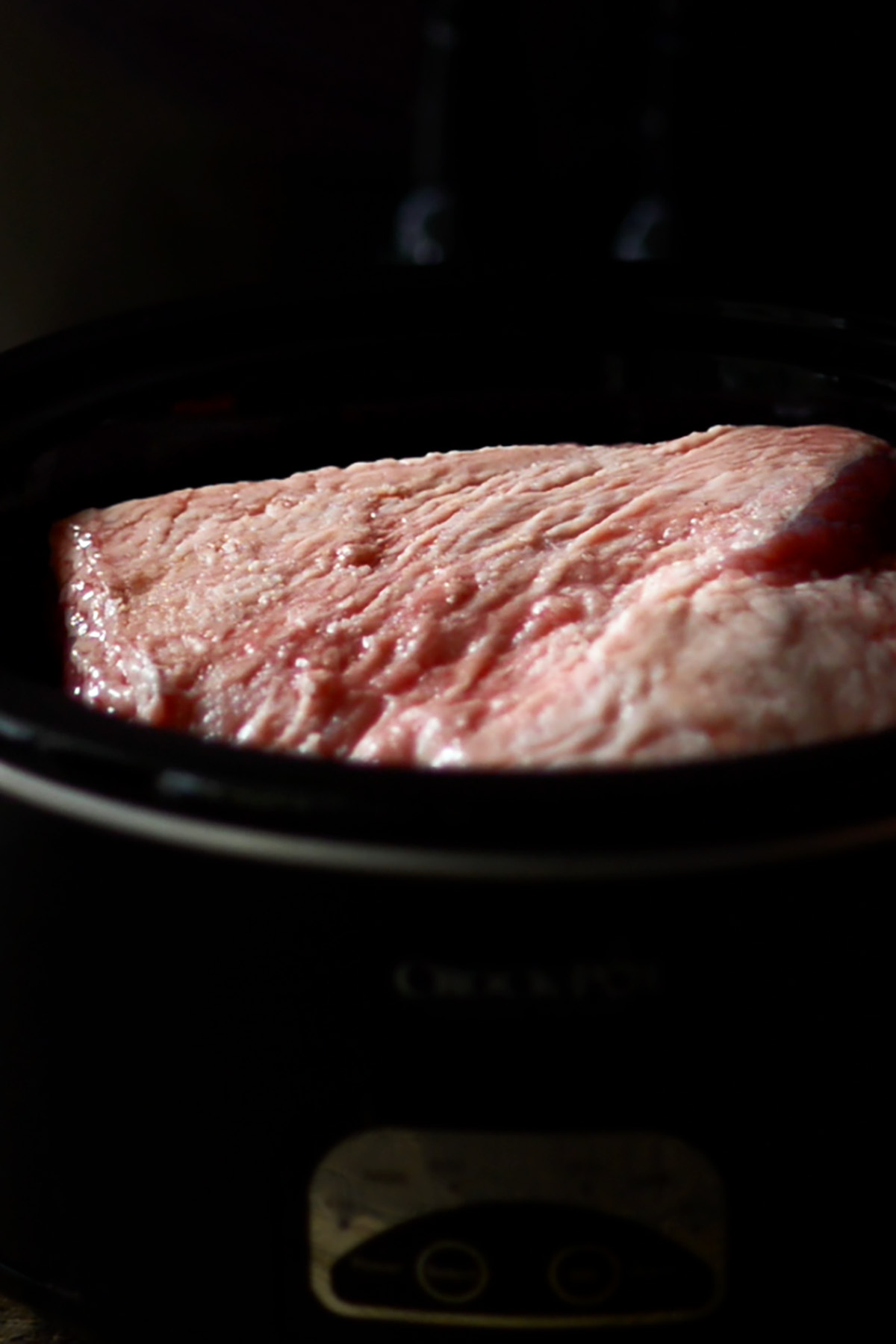 Corned beef brisket in a crock pot fat side up.