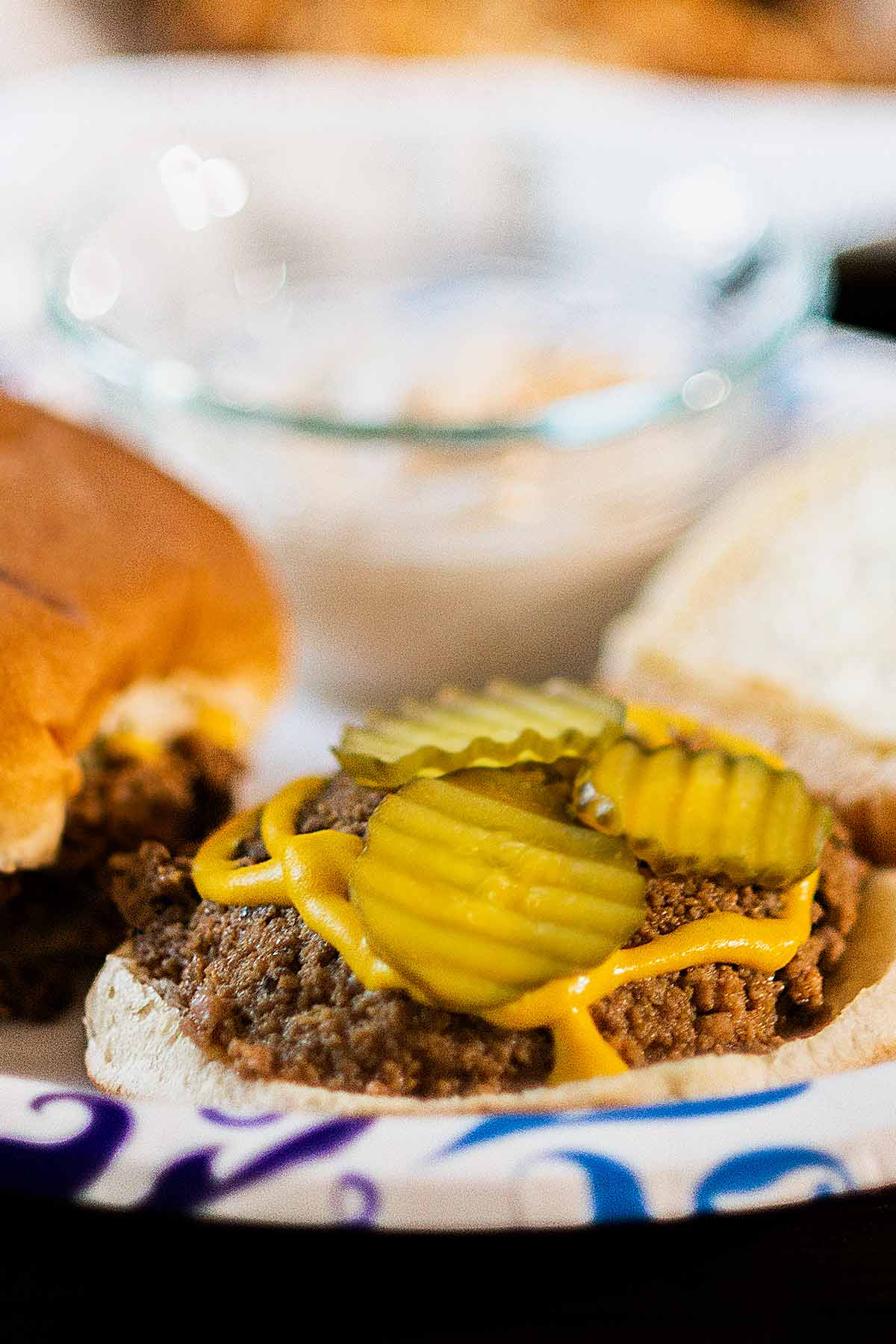 Tastee loose meat sandwich topped with pickles and mustard.