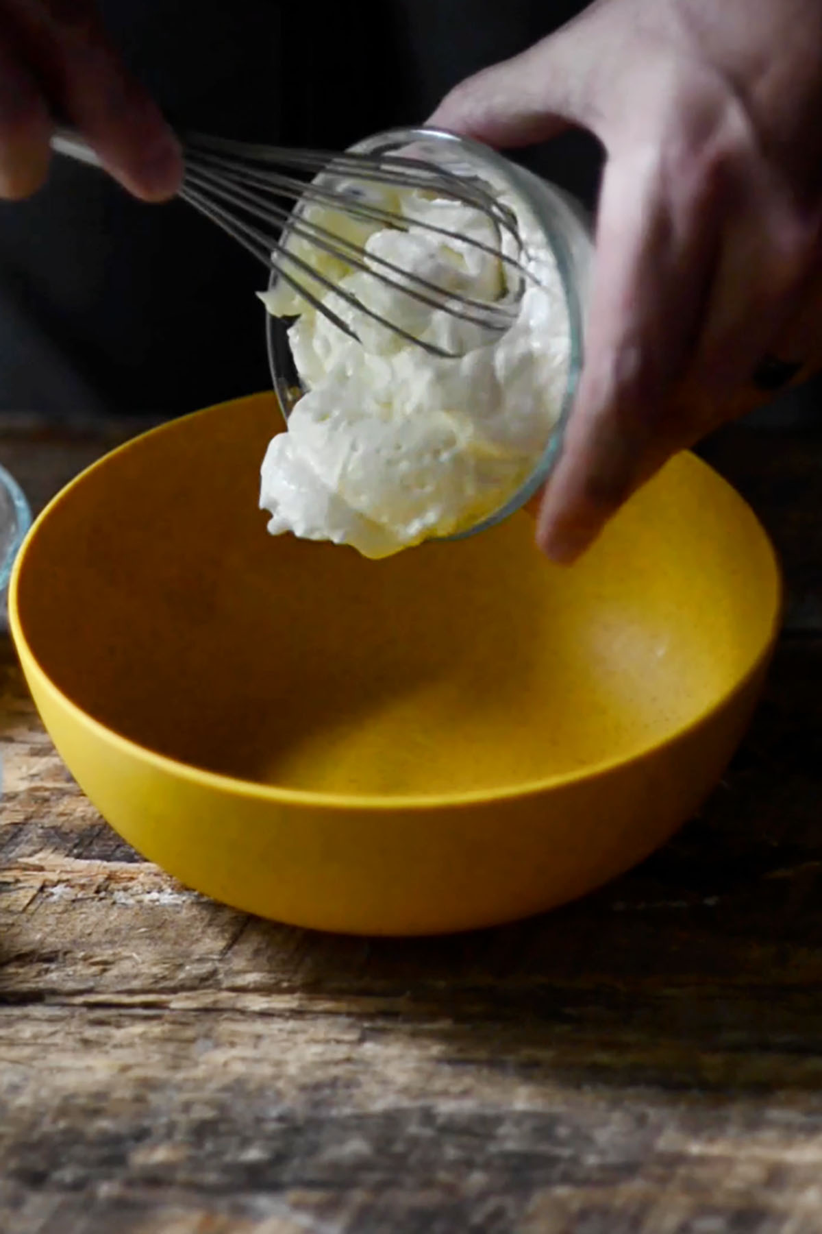 Mayonnaise being added to a small mixing bowl.