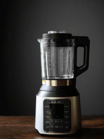 Instant Ace Nova Cooking and Beverage Blender on a wooden counter top.