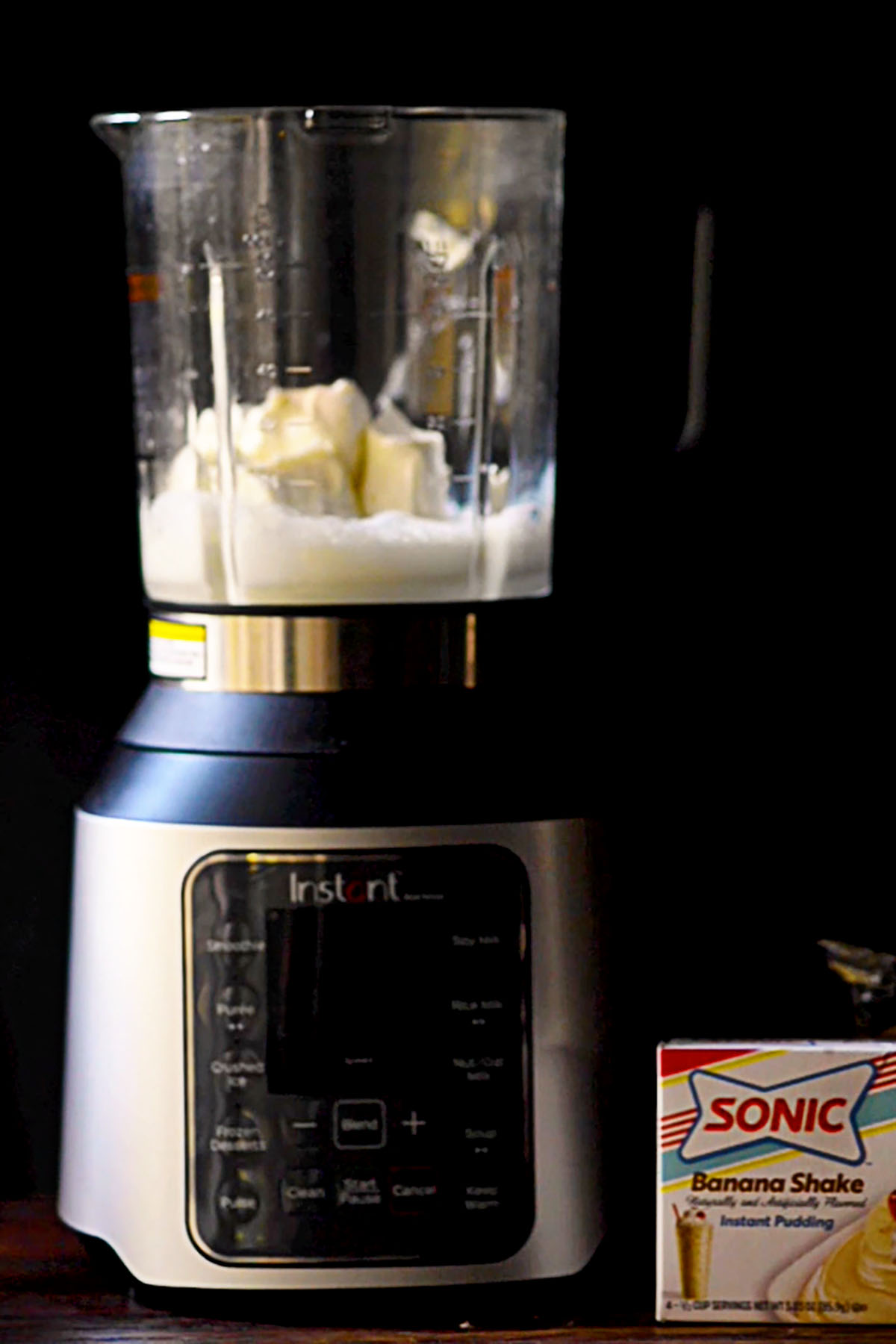 Milk and cream cheese added to a cooking style blender.