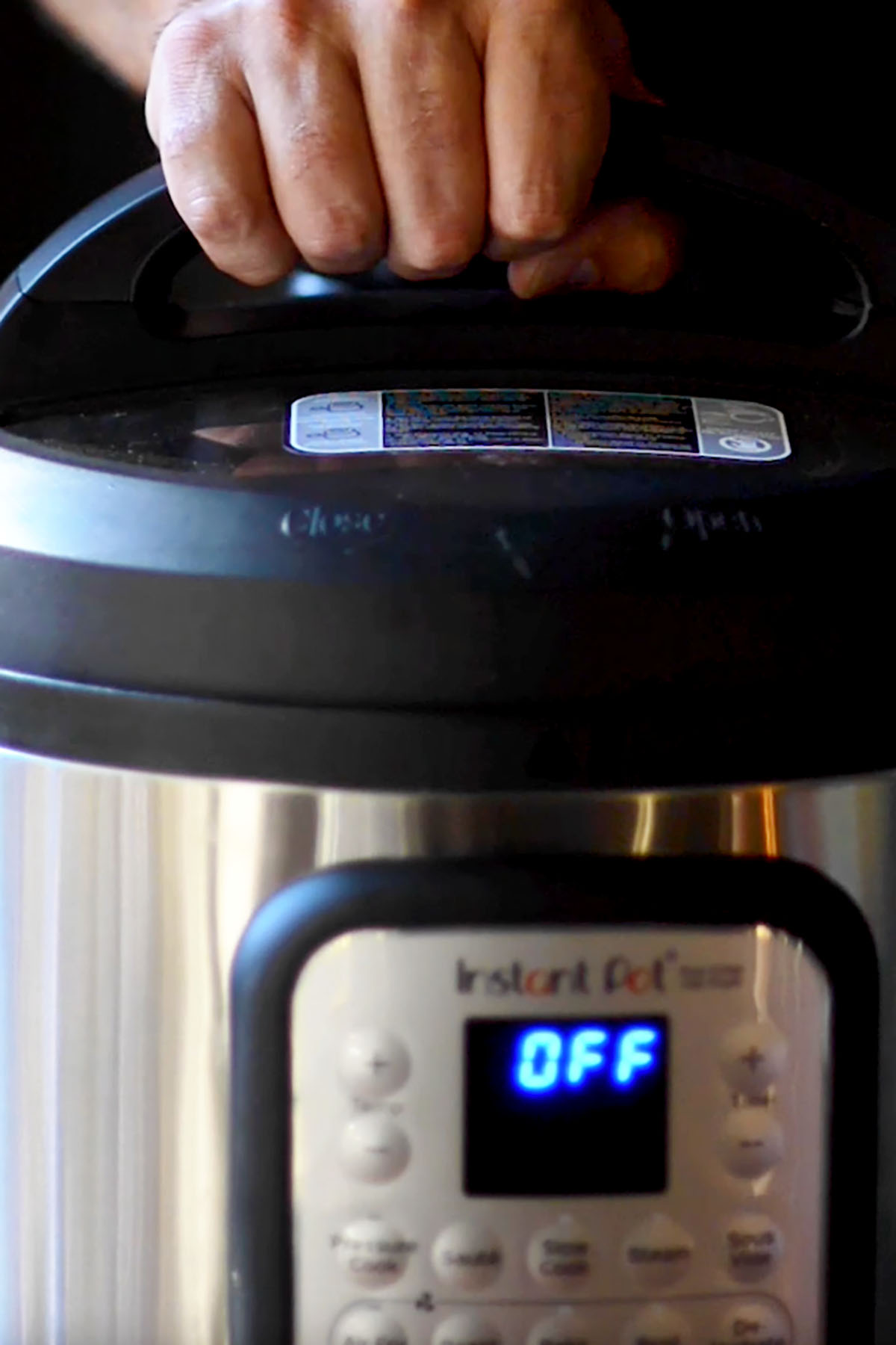 A lid being secured to the top of an Instant Pot.