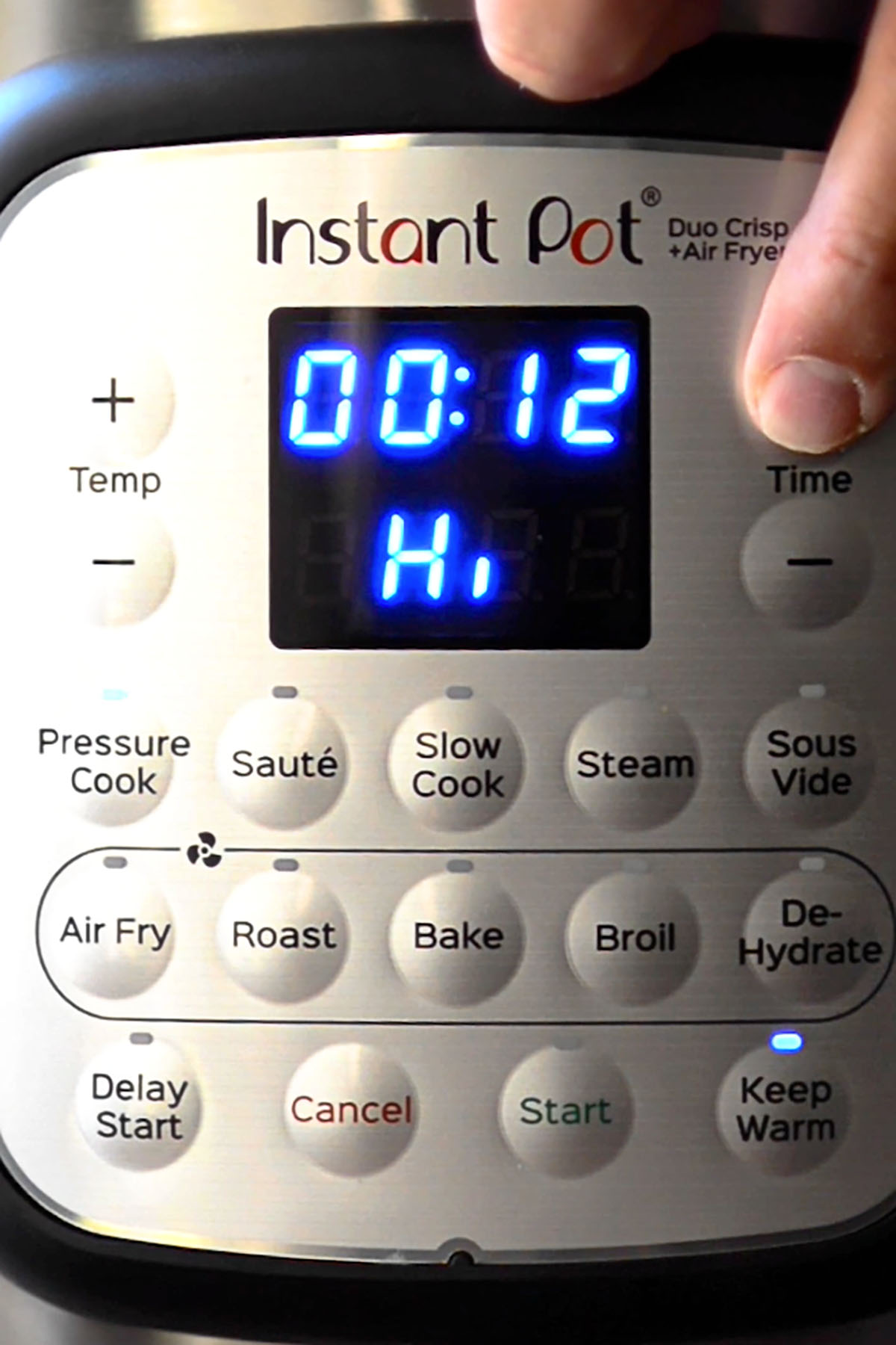 An Instant Pot set to pressure cook on high for 12 minutes.