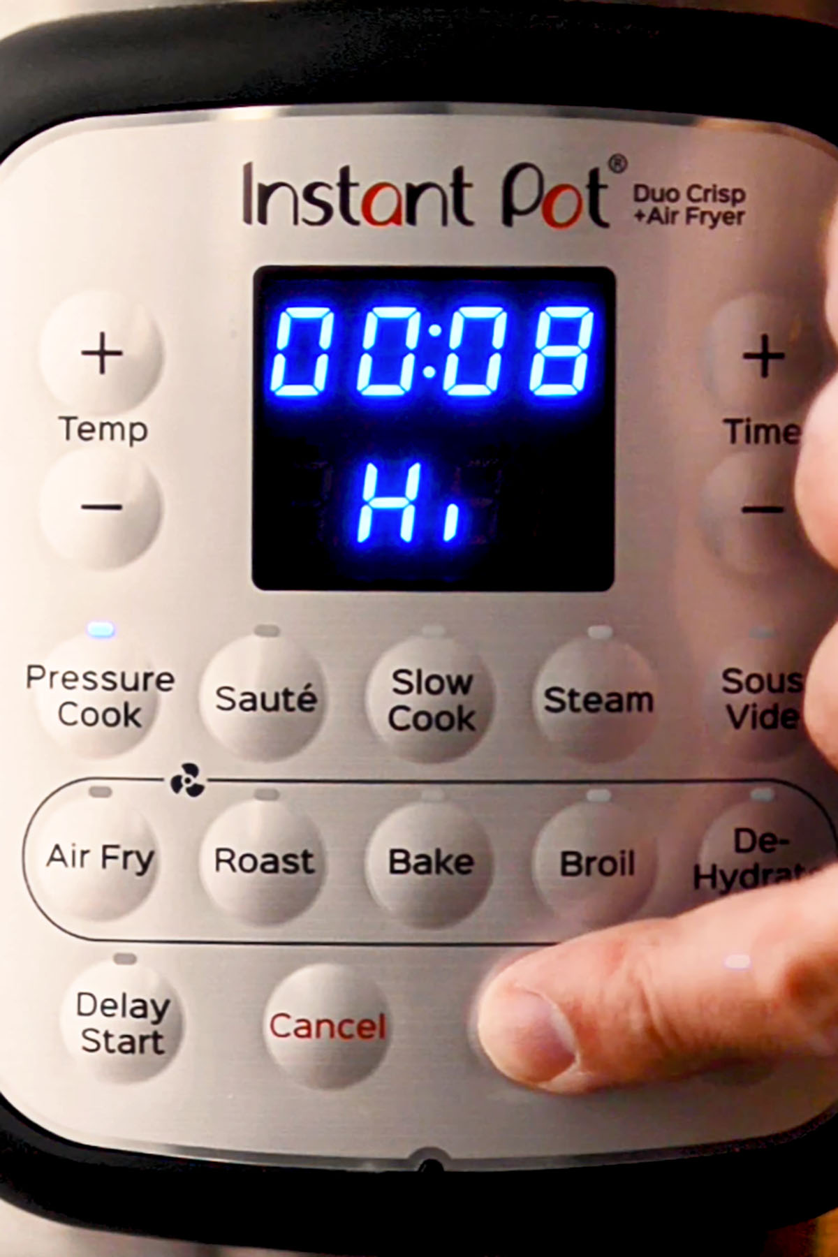 An Instant Pot set to pressure cook on High for eight minutes.