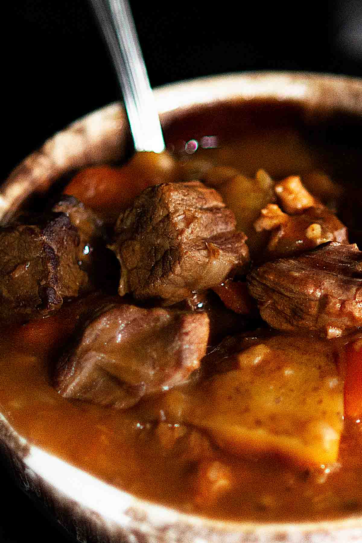 Irish Beef Stew served in a rustic brown and white bowl.