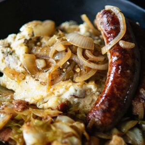 Irish Bangers and Mash served with fried cabbage photographed from the top.