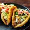 Three Homemade Copycat Taco Bell Santa fe Chalupas served on a black tray.