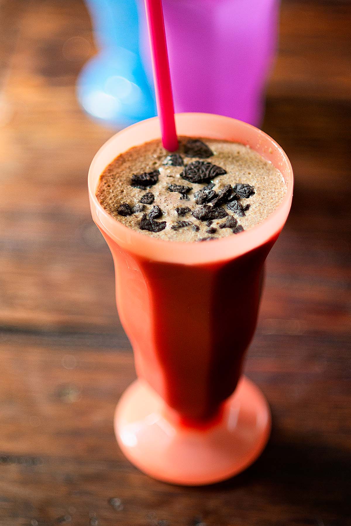 Mocha Latte Oreo Malt served in a peach dessert glass and topped with crushed Oreos.