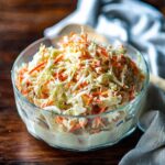 KFC Style Coleslaw with a southern twang served in a clear glass bowl.