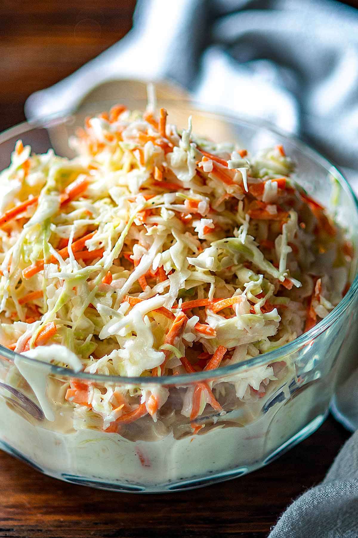 Coleslaw served in a clear serving dish.