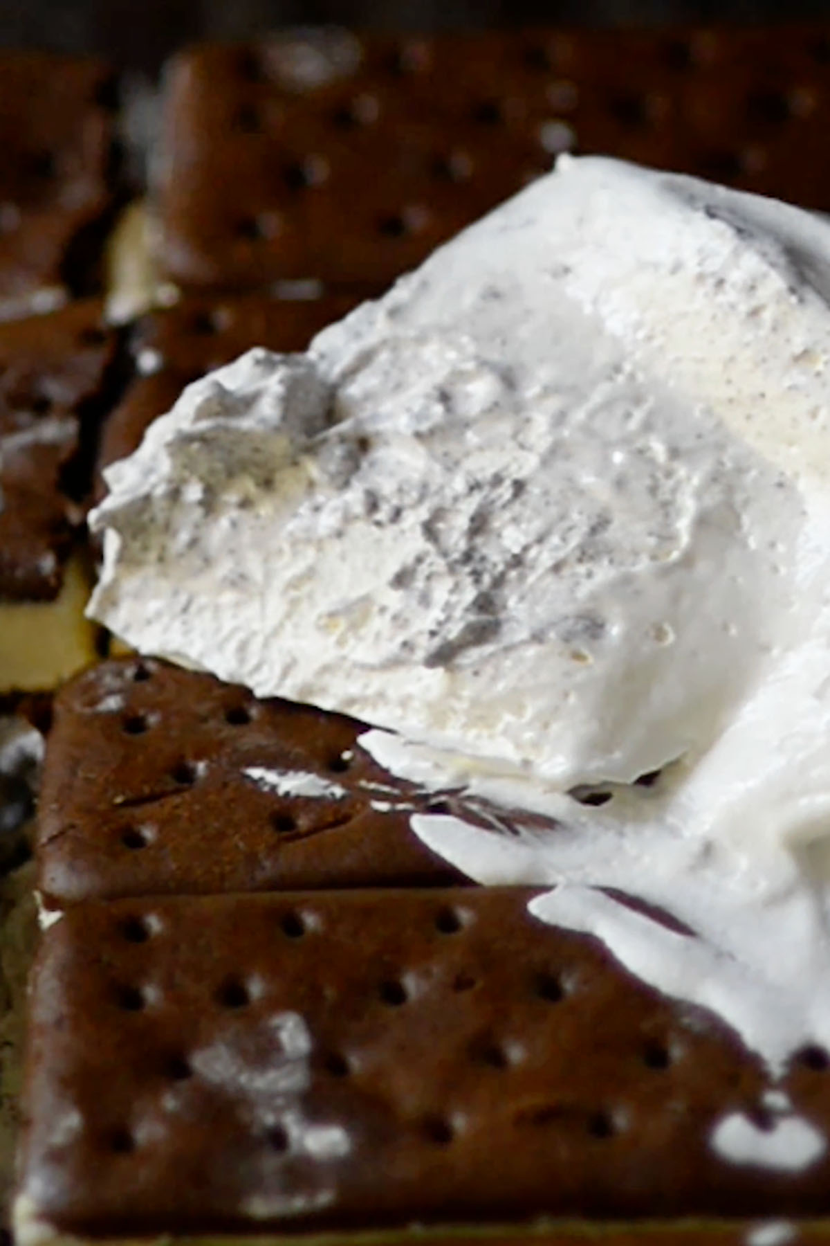 Whipped topping on top of ice cream sandwiches.