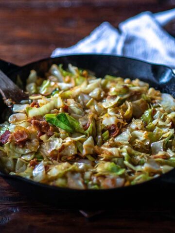 Fried Cabbage served in a cast iron skillet.