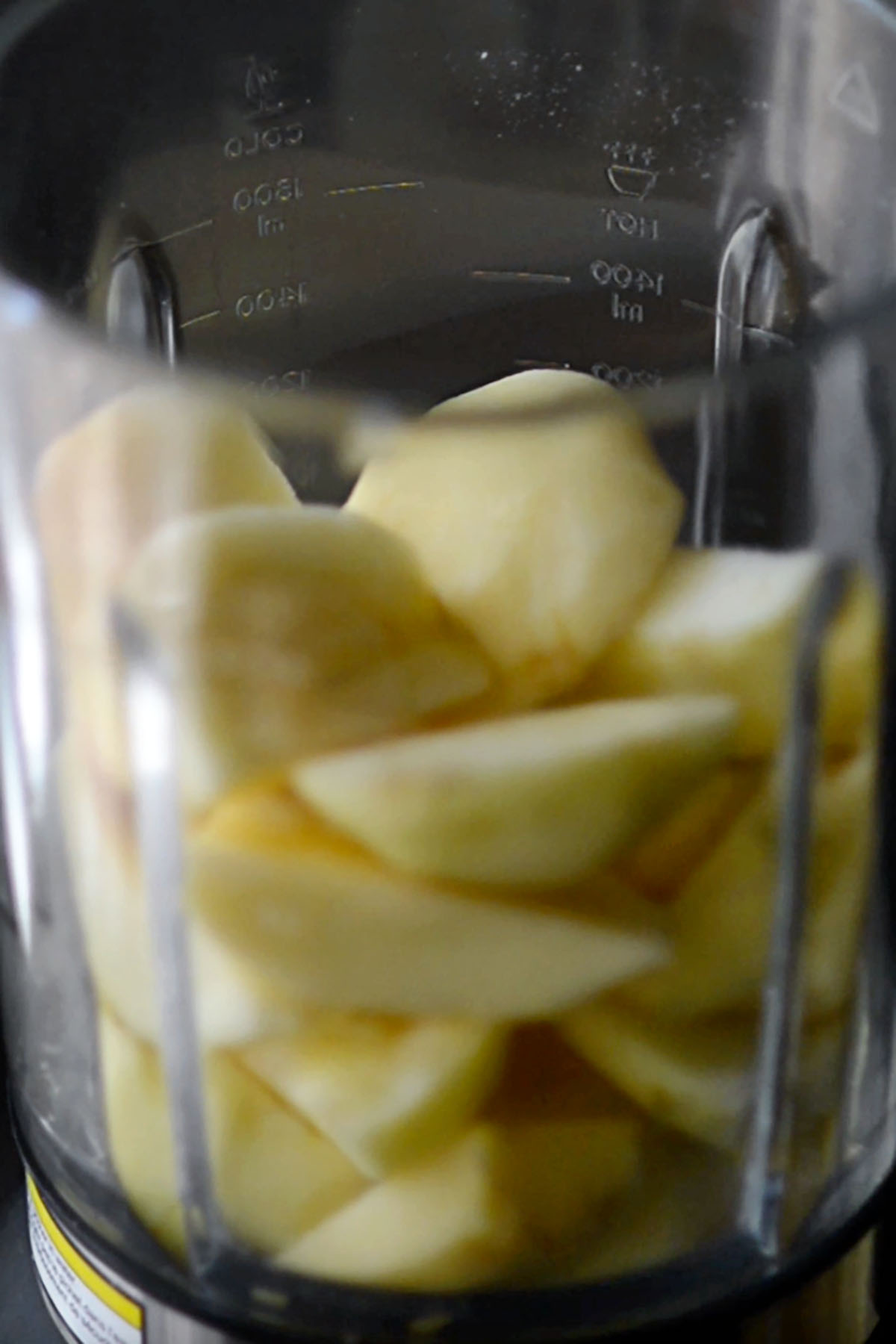 Sliced apples in a blender.