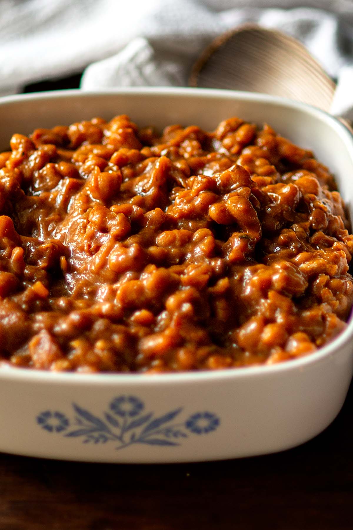 Baked beans in a white serving dish.