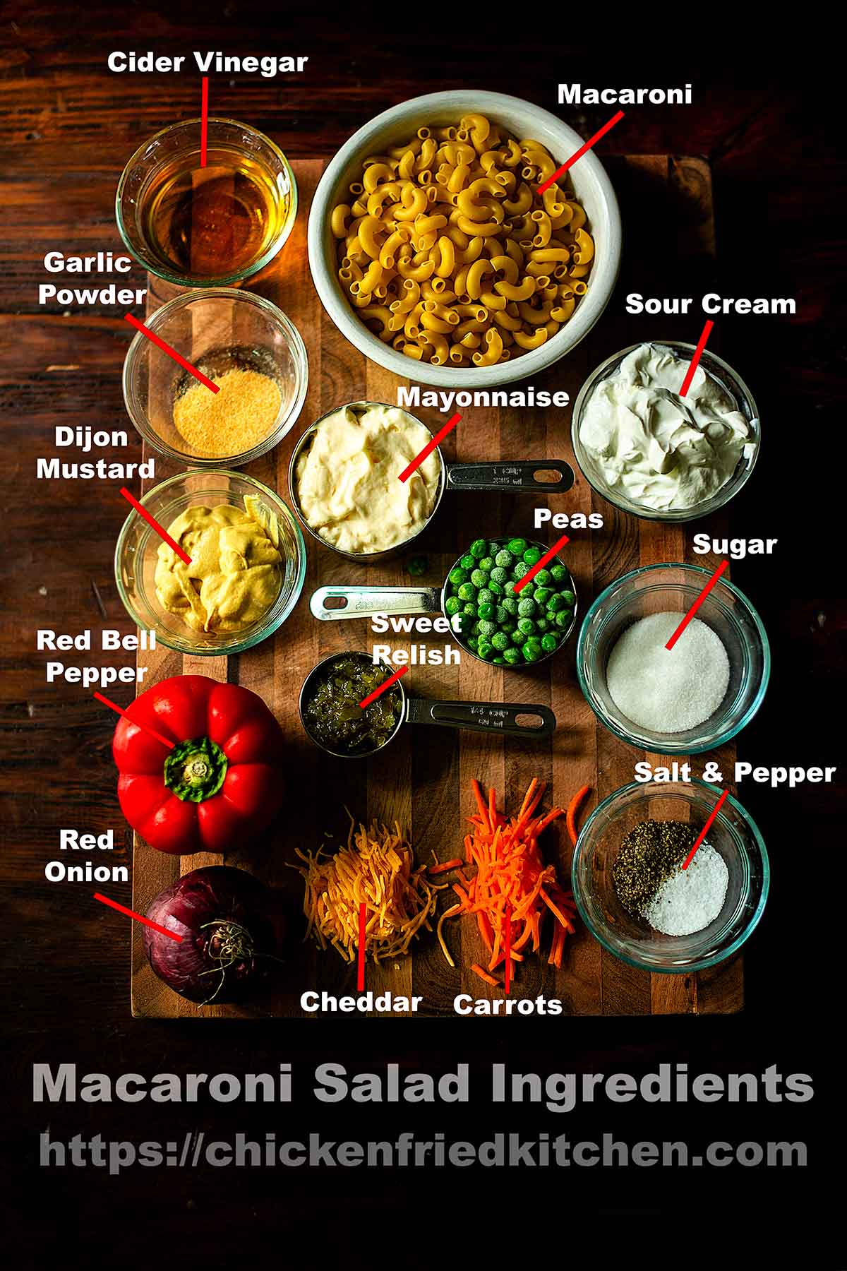 Macaroni salad ingredients labeled and laid out on a wooden table. 
