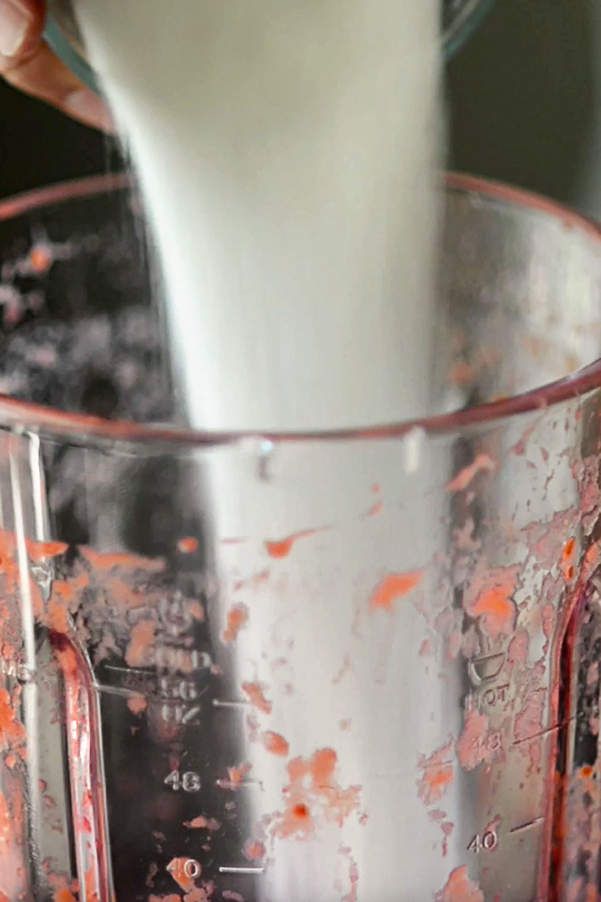 Sugar being poured into a blender.