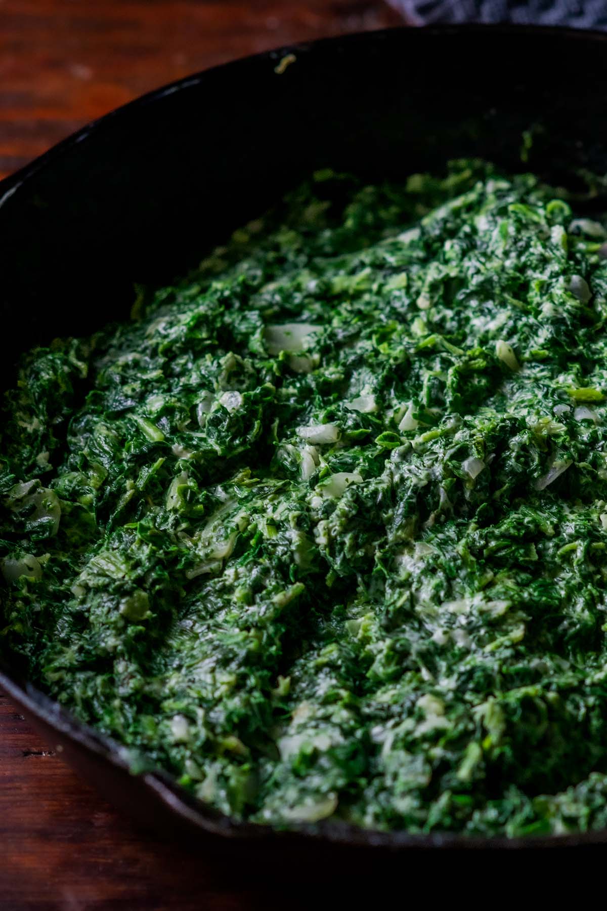 Creamed Spinach in a cast iron skillet.