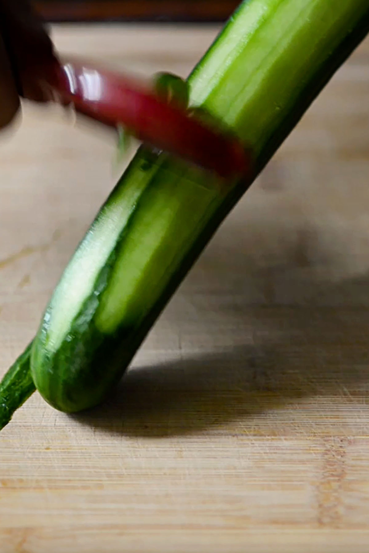 English cucumber being peeled.