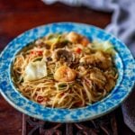 Chicken Mei Fun served with shrimp in a vintage bowl on a wooden table.