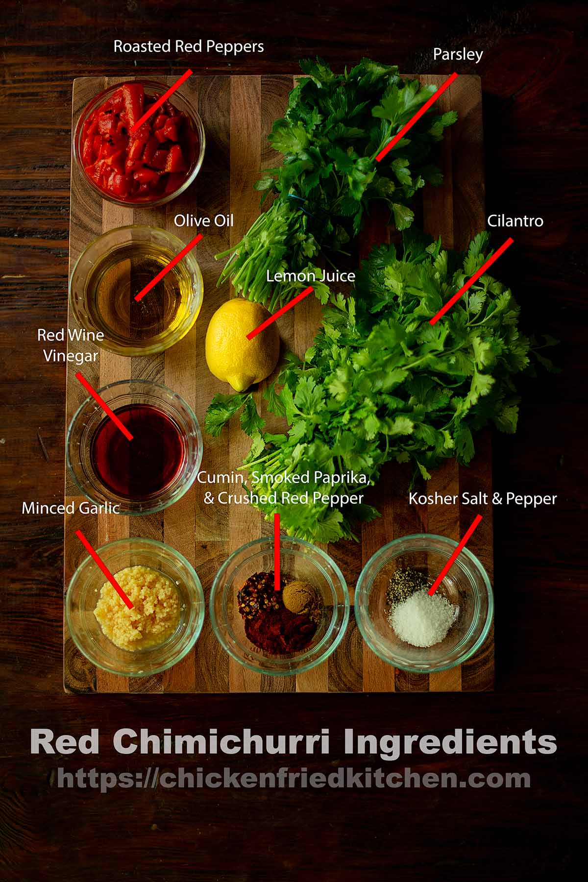 Red Chimichurri ingredients laid out on a wooden table and labeled.