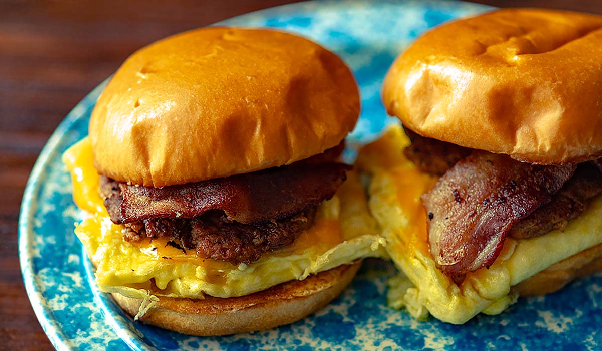 Ultimate Brioche Breakfast Sandwiches served with hatch chile chicken sausage, hatch chile bacon, eggs, and cheese on a brioche bun.