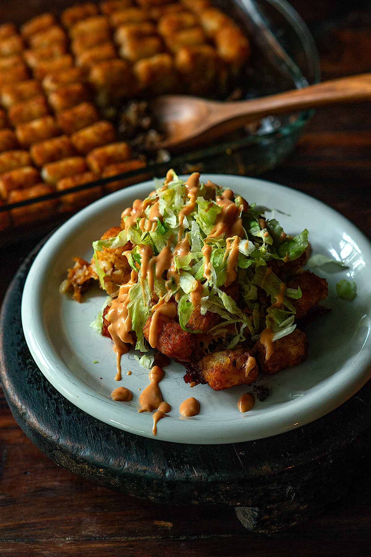 Big Mac Tater Tot Casserole served and topped with shredded lettuce and a drizzle of Thousand Island dressing.