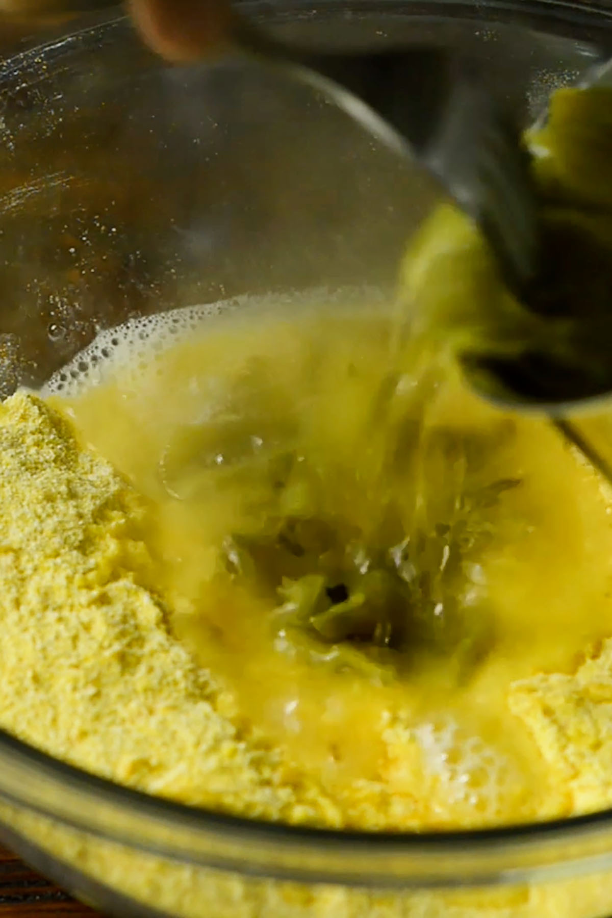 Boiling water being poured into hot water cornbread mix.