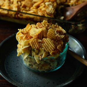 Old Fashioned Tuna Noodle Casserole served family style form a casserole dish topped with extra potato chips.