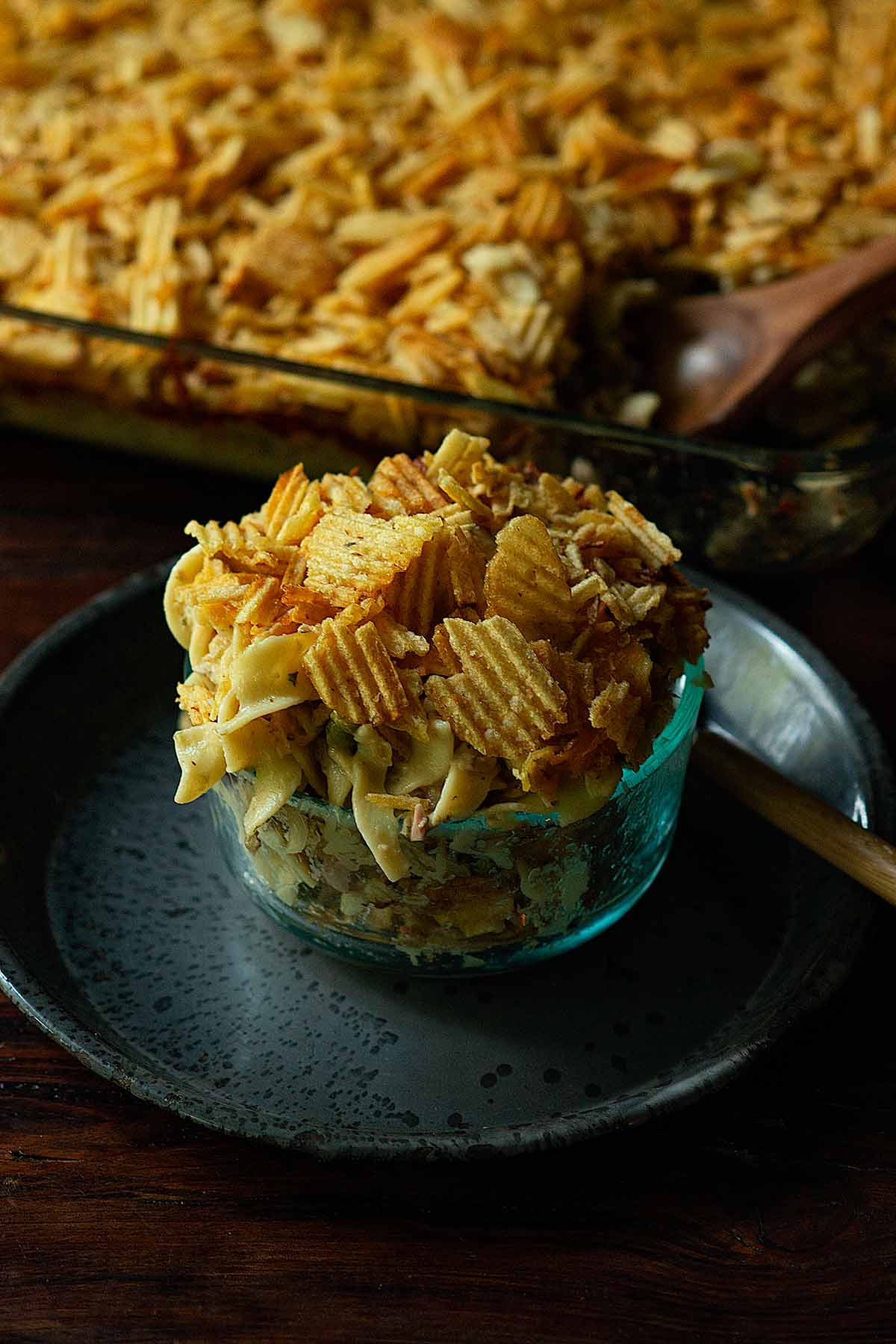 Old Fashioned Tuna Noodle Casserole served family style form a casserole dish topped with extra potato chips.