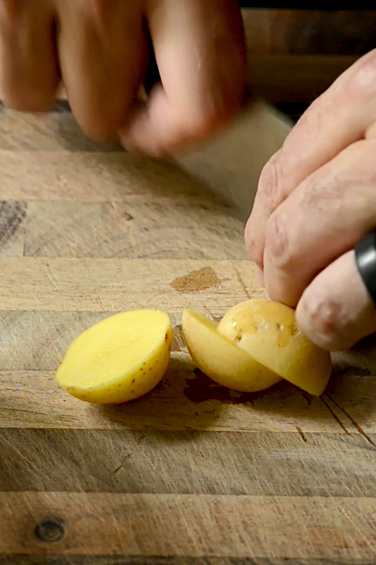 Yellow onions being sliced in half for Yellow Curry.