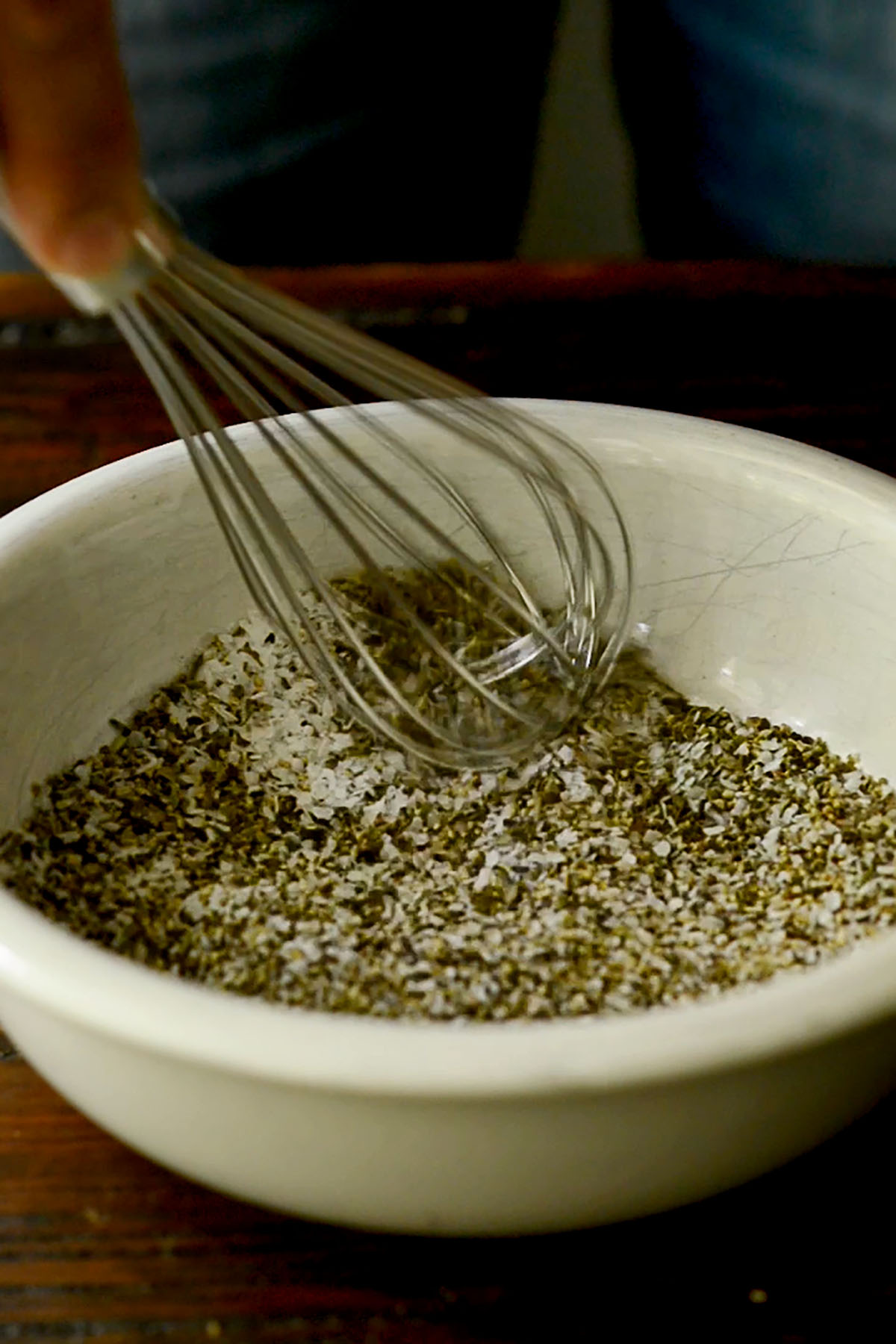 Herbs, spices, and seasoning being combined to create a southern oxtail seasoning.