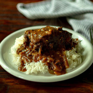 Southern smothered Oxtails and gravy served over rice.