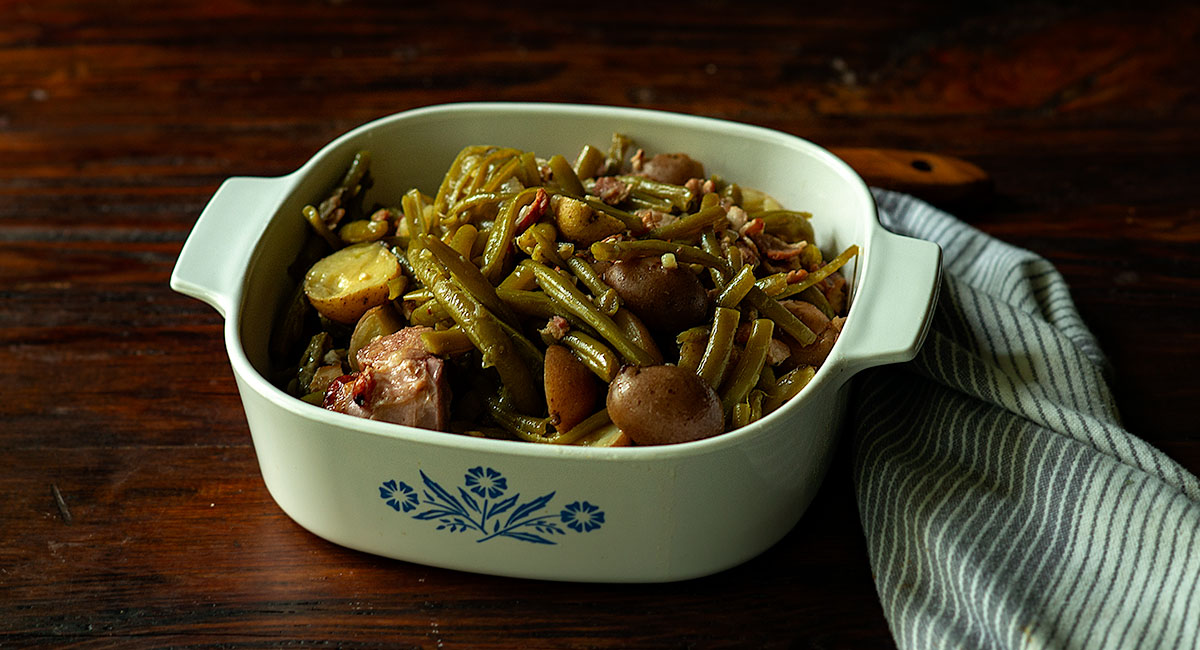 Southern Style Green Beans and Potatoes served in vintage dish.