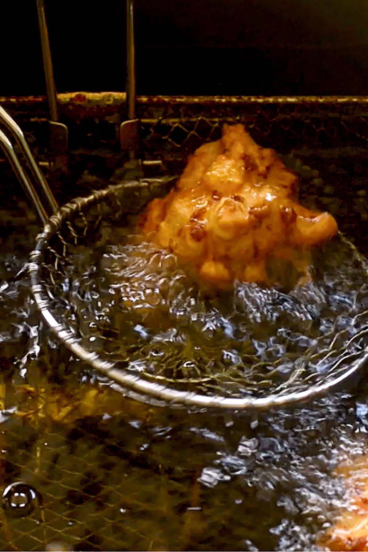 Hominy Fritters deep frying.