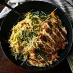 Broccoli Cheddar Pasta with Italian-Style Chicken Cutlet, served in a deep-dish plate.