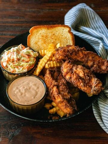 Copycat Raising Cane's Combo Meal with 3 chicken tenders, sauce, coleslaw, fries, and Texas toast.