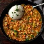 Crawfish étouffée served hot with white rice in a deep dish.