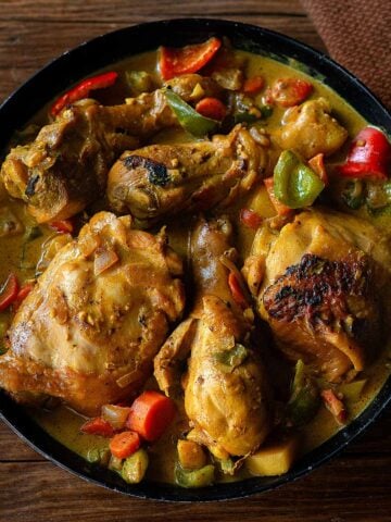 Filipino Chicken Curry Served family style in a deep dish featuring the chicken, curry sauce, and vegetables.