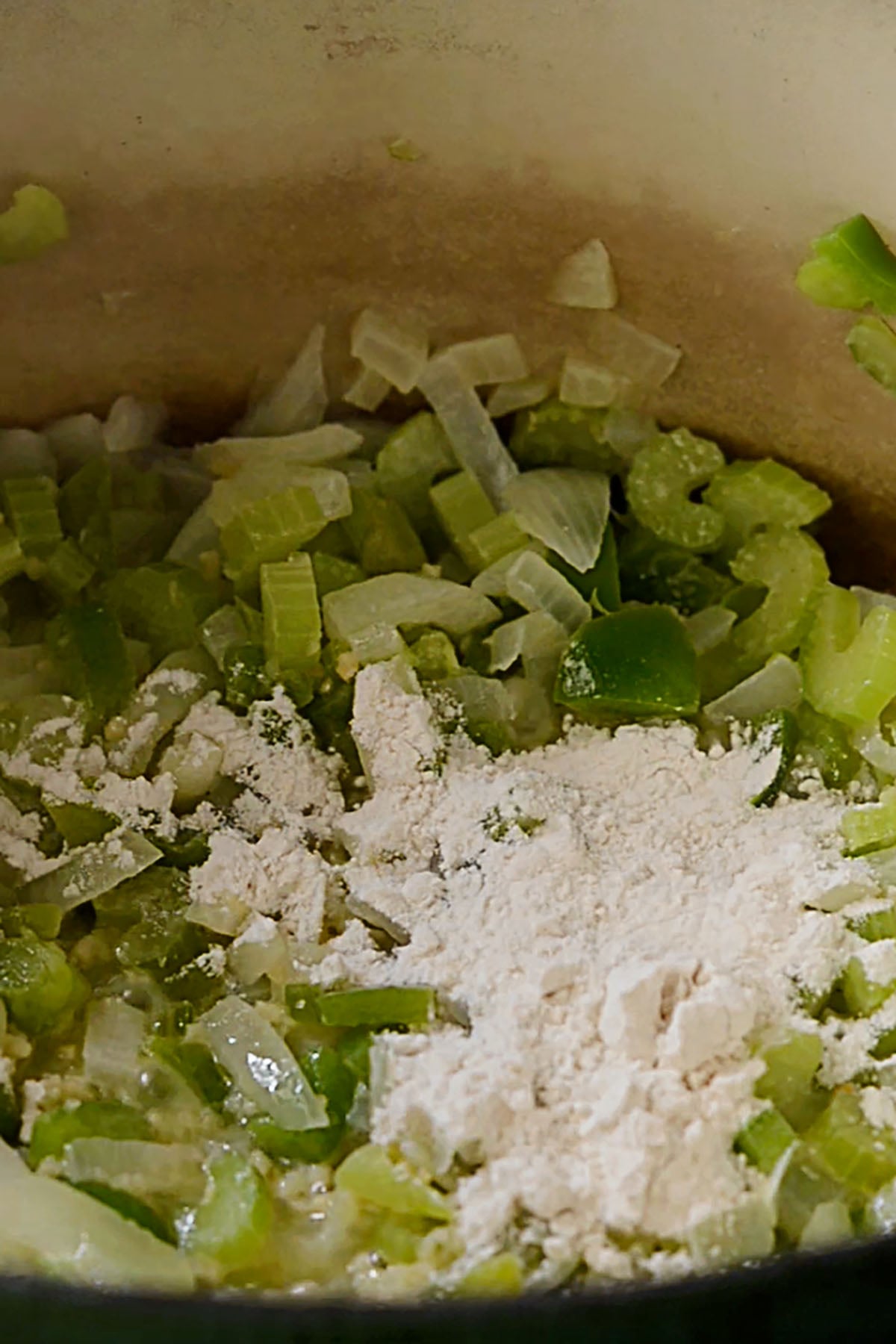 Flour poured over the holy trinity in a dutch oven.