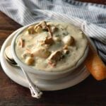 Olive Garden Gnocchi Soup Copycat served with a fresh baked breadstick.